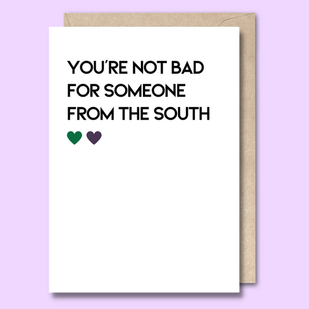 Unseasoned Greetings You’re Not Bad for Someone from the South card with green and purple hearts