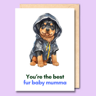 A white greeting card with a watercolour style image of a dog on the front wearing a raincoat. The text at the bottom of the card says 