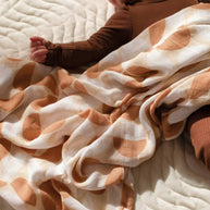Organic cotton and bamboo muslin swaddle with abstract neutral print