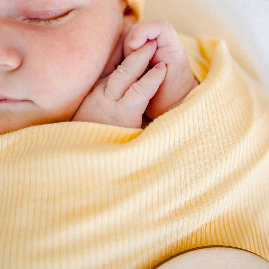 Baby swaddle in buttercup yellow ribbed bamboo fabric