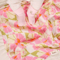 Baby swaddle in Whimsy print with pink, olive and orange florals
