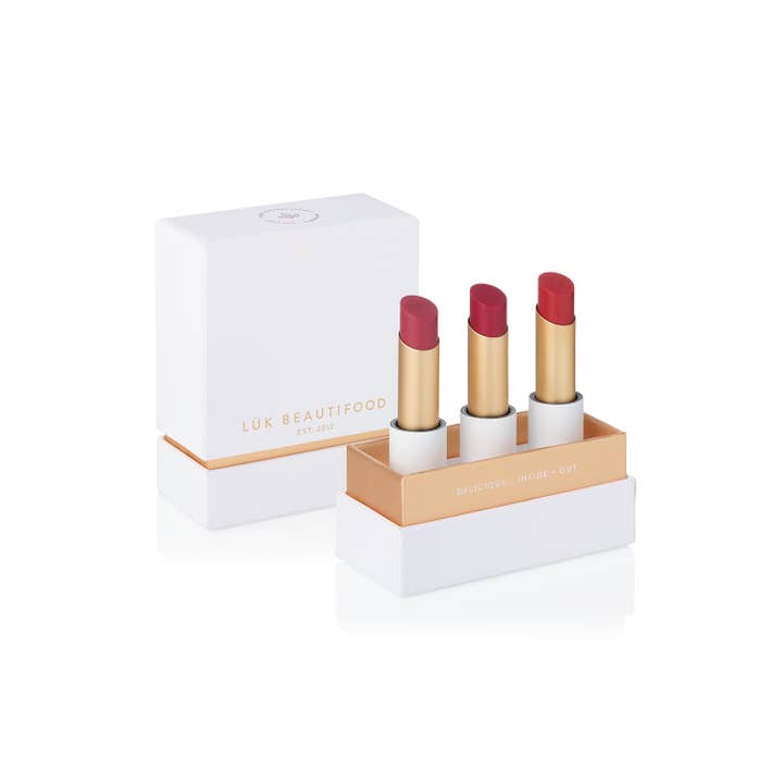 Rosé, Cherry Red, and Cranberry Citrus sheer lipsticks in eco-luxe packaging