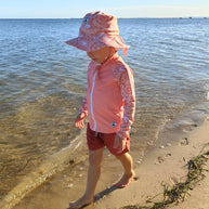 Little E & Co reversible swim hat Community Connected To Land Indigenous Pink