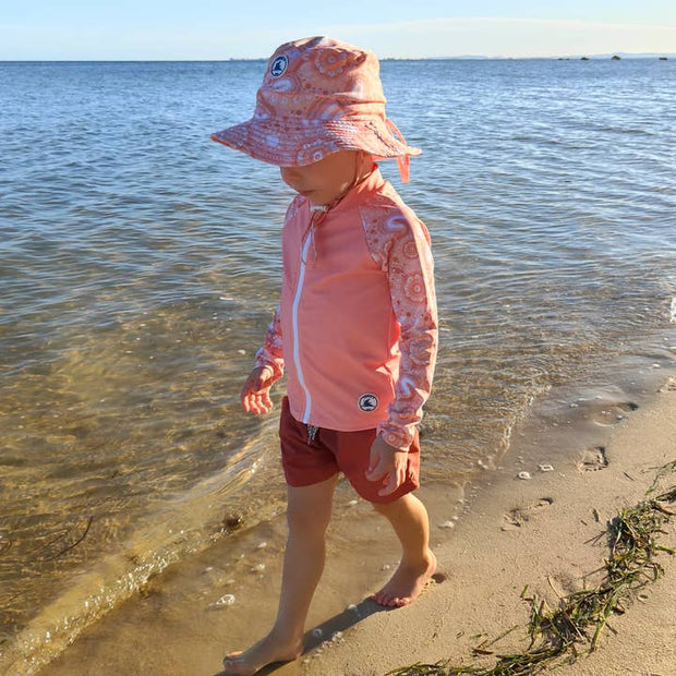 Little E & Co reversible swim hat Community Connected To Land Indigenous Pink