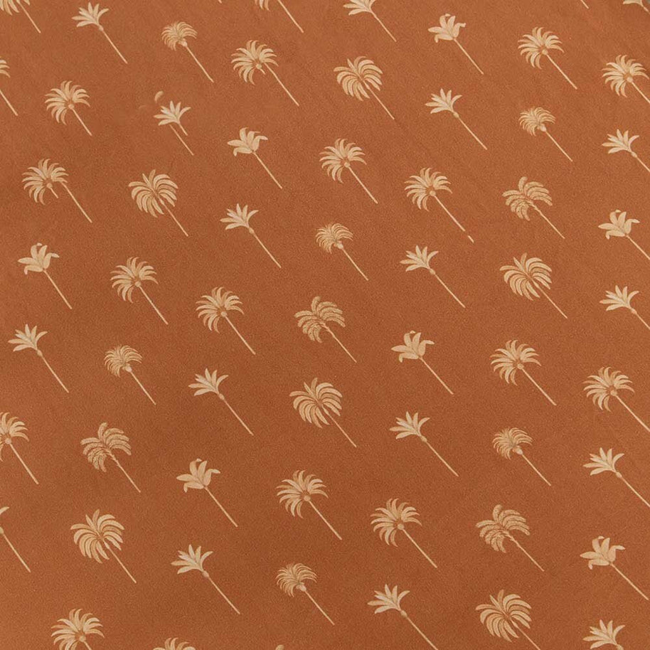Soft organic cotton cot sheet in bronze palm tree print