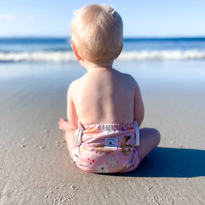 Reusable swim nappy with matching waterproof mini wet bag in Australian animals print