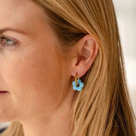 Gold hoop earrings with removable blue resin flower charm