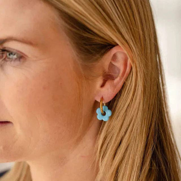 Gold hoop earrings with removable blue resin flower charm