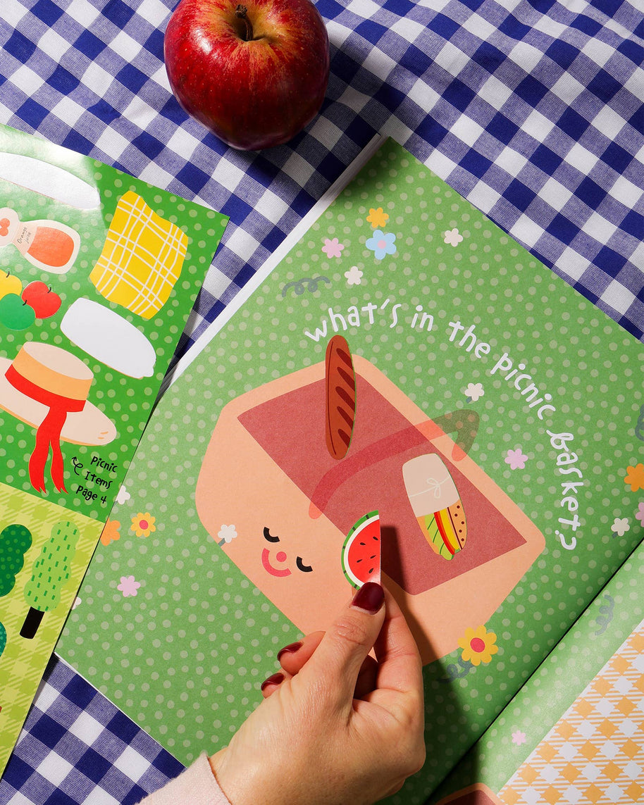 Sticker book pages with picnic, playground and pond scenes