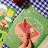 Sticker book pages with picnic, playground and pond scenes