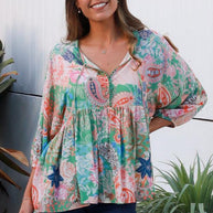 Model wearing the DreamCatcher Bohemian Top in a colourful floral and paisley print with a loose, flowy fit.