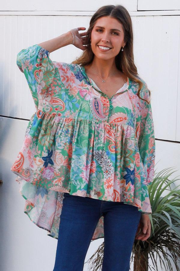 Model wearing the DreamCatcher Bohemian Top in a colourful floral and paisley print with a loose, flowy fit.