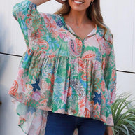 Model wearing the DreamCatcher Bohemian Top in a colourful floral and paisley print with a loose, flowy fit.