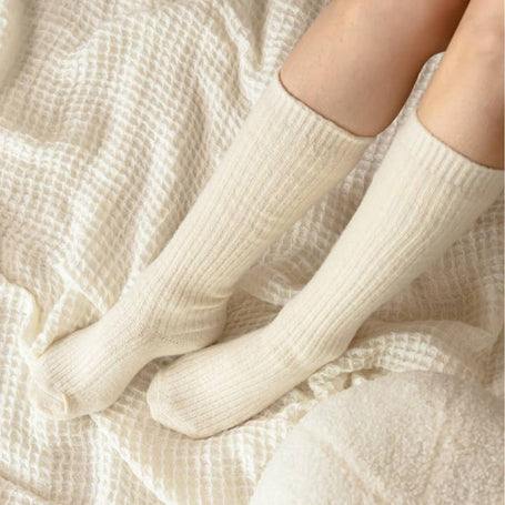 Bed and Butter The Comfiest Socks Knee High Cream cashmere wool socks worn on bed
