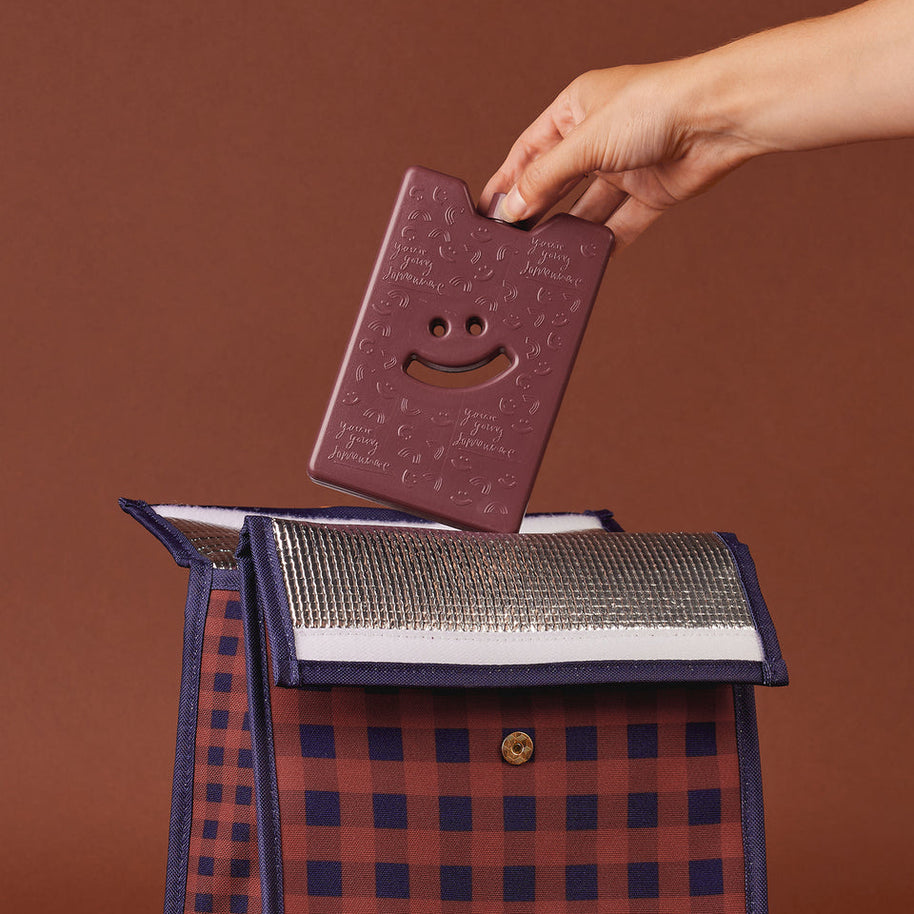 Slim reusable ice pack with embossed smiley design