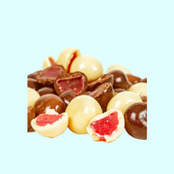 Raspberry lollies coated in milk, dark, and white chocolate