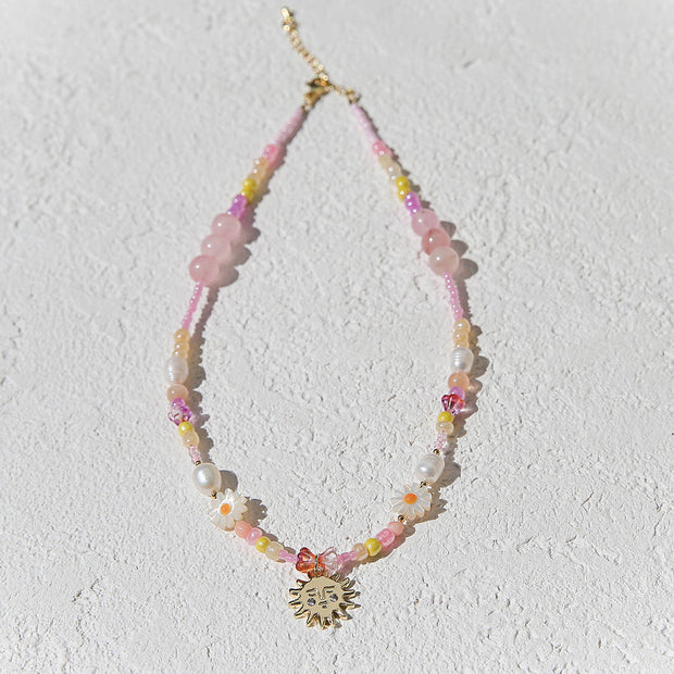 Handmade beaded necklace in peach and gold tones