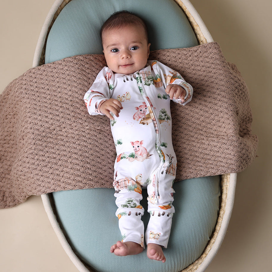 Soft zip-up organic cotton romper with foldover feet and Farm print